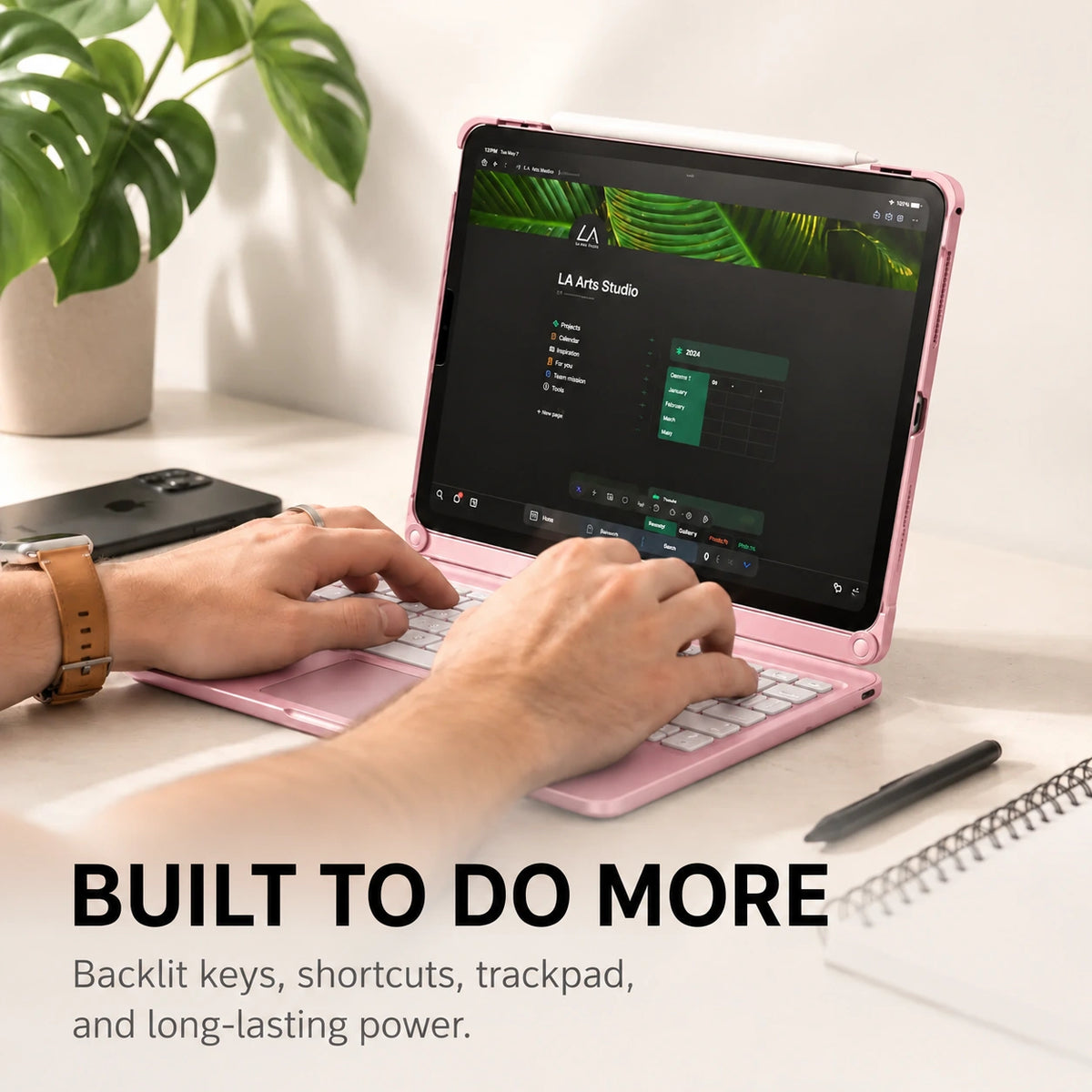Rose Pink iPad keyboard case in use at a desk with a Burgundy iPhone beside it. #color_Rose Pink